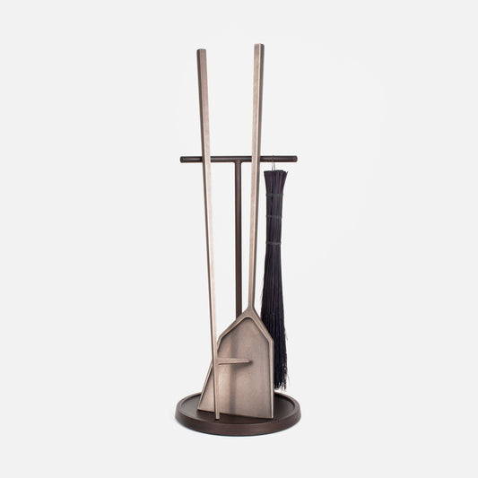 A fireplace toolset shown in an oxidized bronze finish made up of a shovel, poker and brush.