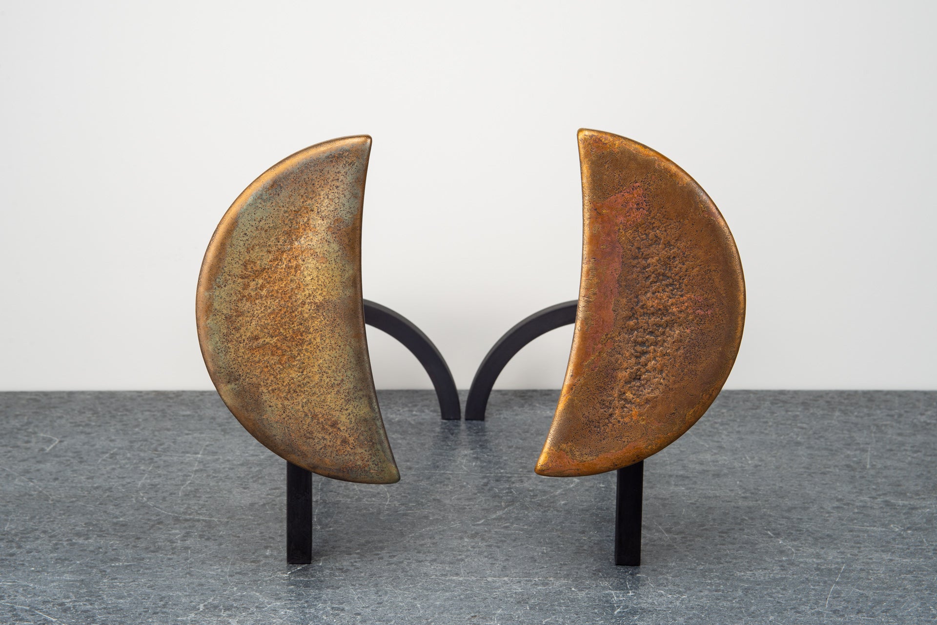 Borough Furnace Moon Andirons: sculptural crescent bronze finials on blackened steel firedog frame