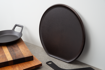 The distinctive flat edge on this heavy pizza griddle prevents it from rolling when stored upright.