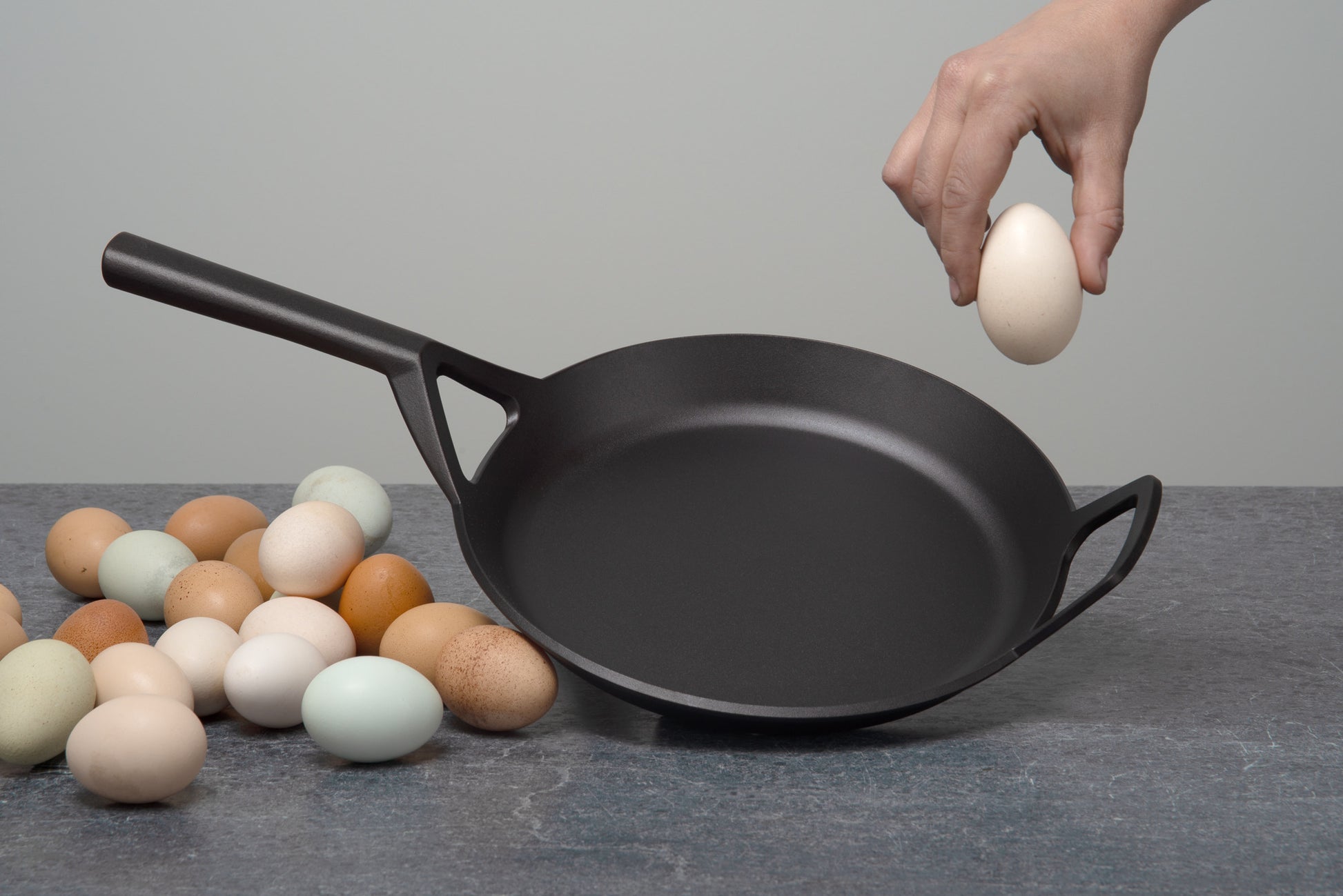 Borough Furnace 10.5" skillet with heritage eggs and hand for scale