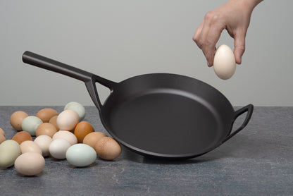 Borough Furnace 10.5" skillet with heritage eggs and hand for scale